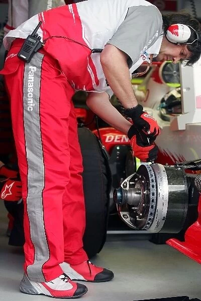 Formula One World Championship: A Toyota mechanic works on the car