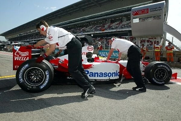 Formula One World Championship: The Toyota team push Cristiano Da Matta Toyota TF103 into the garage