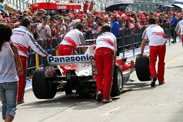 Formula One World Championship: A Toyota TF106 is pushed up the pitlane during the pit lane walkabout