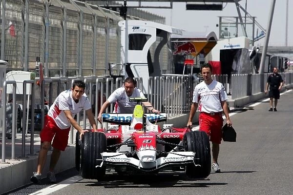 Formula One World Championship: Toyota TF108 is pushed down the pit lane