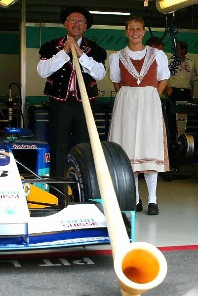 Formula One World Championship: Some traditional Swiss Alphorn players help the Sauber team celebrate National Swiss Confederation Day