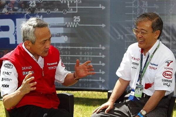 Formula One World Championship: Tsutomu Tomita Chairman of Toyota Racing and Toyota Team Principal talks with Tetsuo Hattori Toyota Motor Corporation