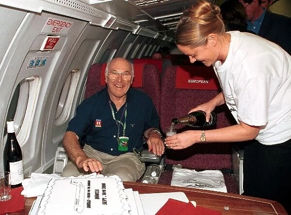 Formula One World Championship: TV Commentator Murray Walker relaxes with a glass of champagne after he commentated on his final European Grand Prix