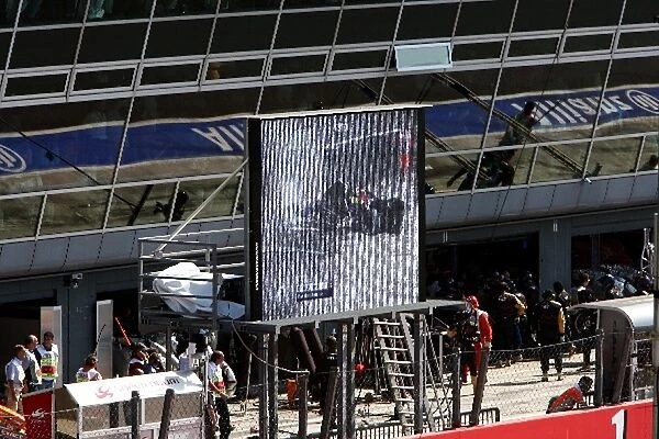 Formula One World Championship: TV screens show the crash of David Coulthard Red Bull Racing RB3