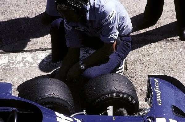 Formula One World Championship: A Tyrrell mechanic checks the tyres on a six-wheeled P34