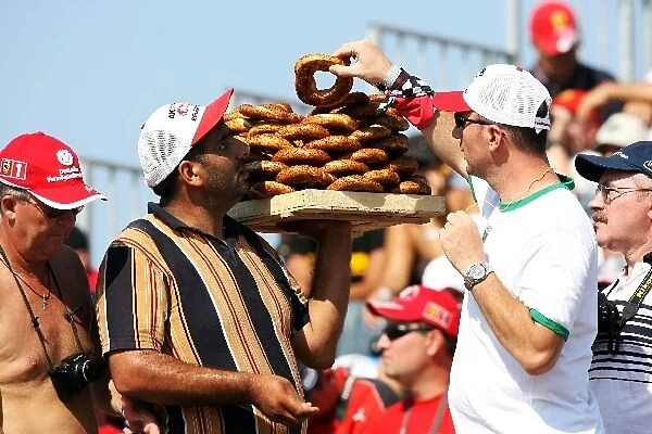 Formula One World Championship: A vendor sells savoury snacks to a fan