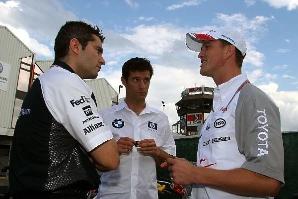 Formula One World Championship: A Williams engineer talks with Mark Webber Williams and Ralf Schumacher Toyota