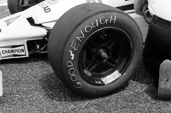 Formula One World Championship: A Williams mechanic has modified the Good Year tyre on the FW06 to read Good Enough