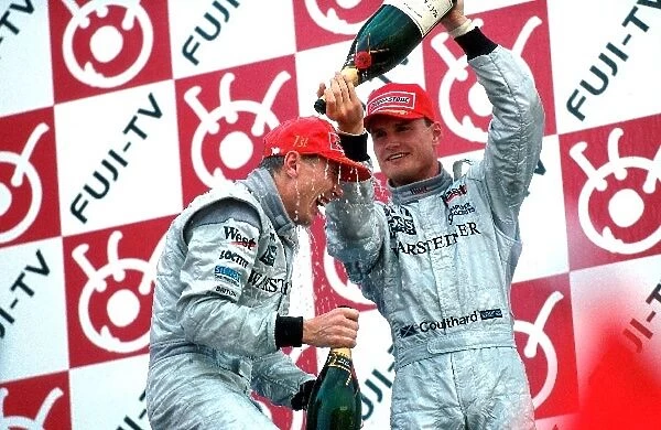 Formula One World Championship: Winner Mika Hakkinen, McLaren MP4-13, celebrates with team-mate David Coulthard, McLaren MP4-13, 3rd place
