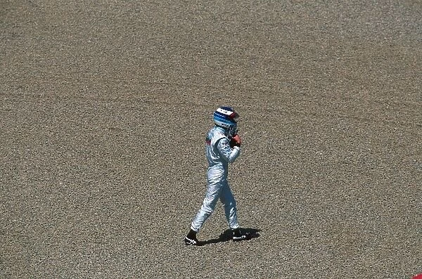 Formula One World Championship: Winner Mika Hakkinen Mclaren MP4-14 walks back to the pits after crashing in practice