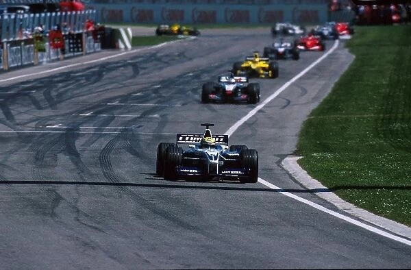 Formula One World Championship: Winner Ralf Schumacher BMW Williams FW23 leads the pack in the early stages of the race