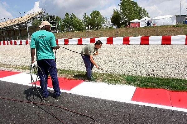 Formula One World Championship: Workmen paint the grass green