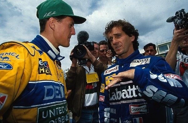 Formula One World Championship: World Champion Alain Prost, right, talks with Michael Schumacher