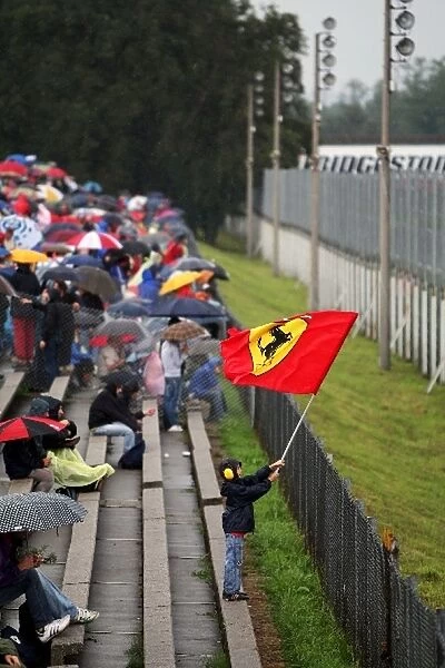 Formula One World Championship: A young fan waves a Ferrari flag