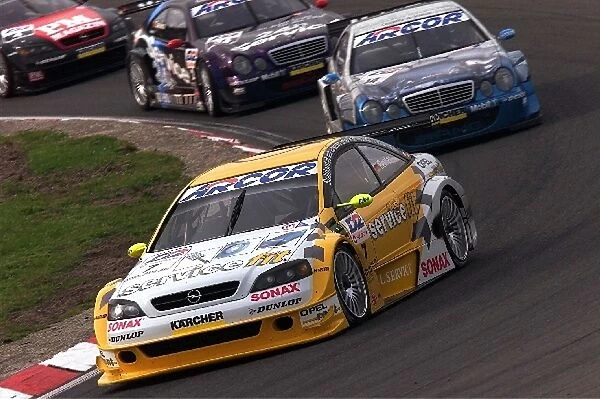 German DTM Championship: Manuel Reuter Opel Astra V8 Coupe leads a train of DTM cars around Zandvoort