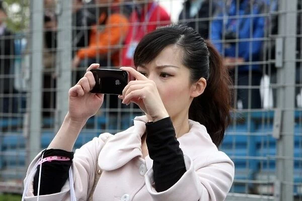 DTM. A girl taks a picture on the grid.. DTM, Rd11, Shanghai, China, 26-28 November 2010