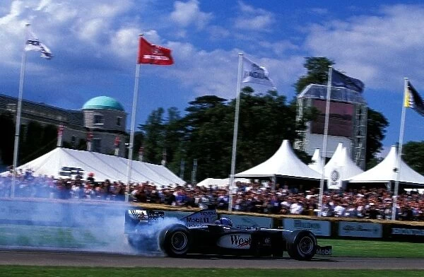 Goodwood Festival of Speed: McLaren test driver Darren Turner lights up the rear tyres in a 2001 McLaren Mercedes MP4  /  16