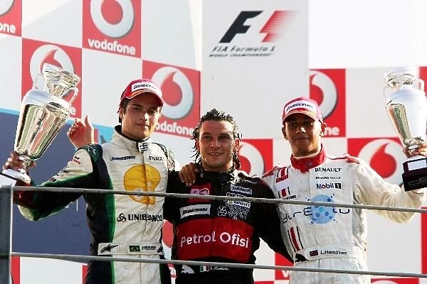 GP2: The podium: Nelson Piquet Jnr. Piquet Sports, second; Giorgio Pantano FMS International, race winner; Lewis Hamilton ART Grand Prix, third