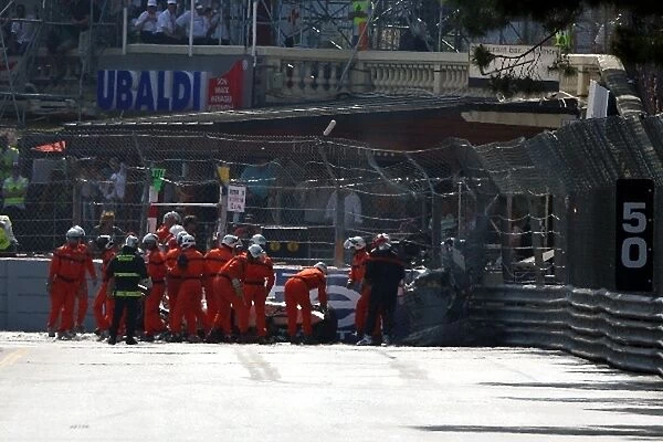 GP2 Series: Marshals recover the car of Romain Grosjean Barwa Addax Team after a crash