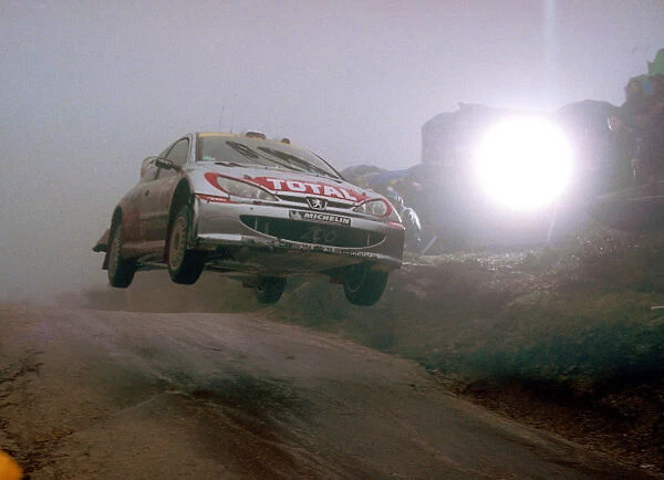 Harri Rovanpera flies over the famous Fafe jump in terrible weather conditions in his Peugeot 206 WRC