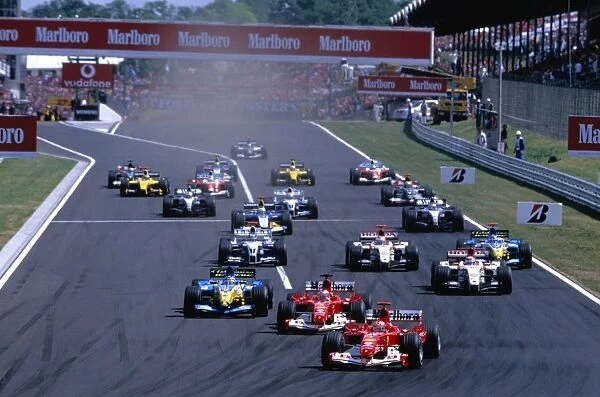 Hungaroring, Hungary. 13th - 15th August: Michael Schumacher, Ferrari F2004 leads the field down to the first corner from the start. Action