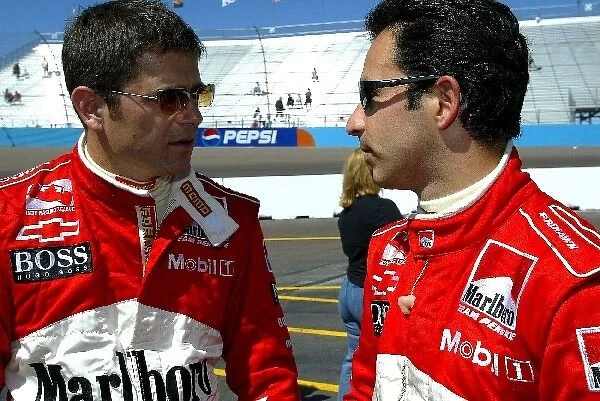 Indy Racing League: Marlboro Team Penske drivers, Gil de Ferran, left, and Helio Castroneves, right, talk set ups before qualifying for the Copper