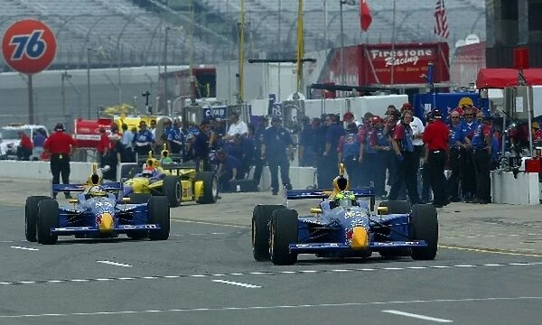 Indy Racing League: Red Bull Team Cheever rookie drivers, Tomas Scheckter and Buddy Rice leave the pits during practice for the Michigan Indy 400