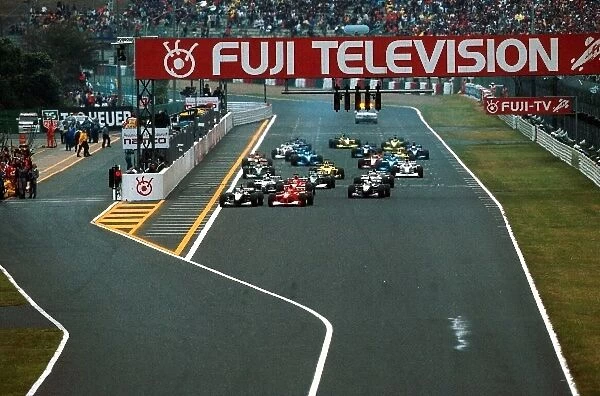 Japanese GP Formula One World Championship: The start of the race. Mika Hakkinen gets the jump on Schumacher and the rest of the field
