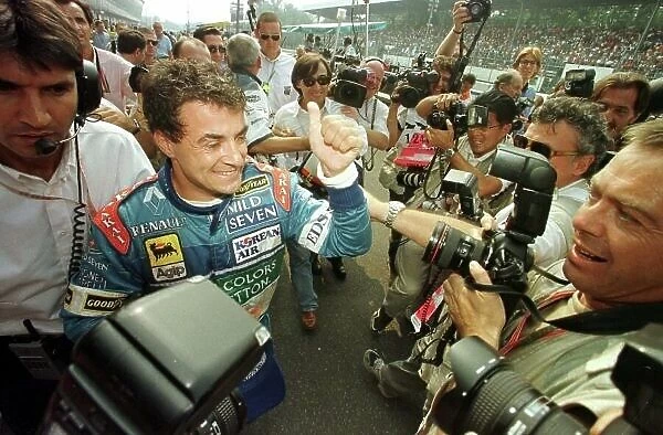 JEAN ALESI GIVES THE THUMBS UP AFTER SECURING POLE POSITION AT THE ITALIAN GP'97. PHOTO:LAT / COATES