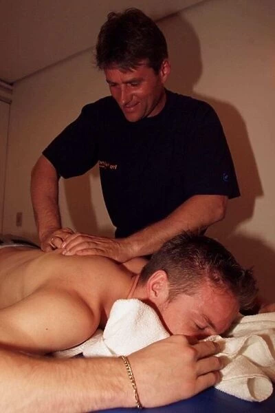 Jenson Button gets a massage after qualifying