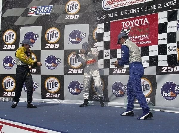 Lavi, Yasukawa, and Macri, (l to r), celebrate with champagne after the Toyota Atlantis race following the Miller Lite 250. The Milwaukee Mile, Milwaukee, Wi. 02