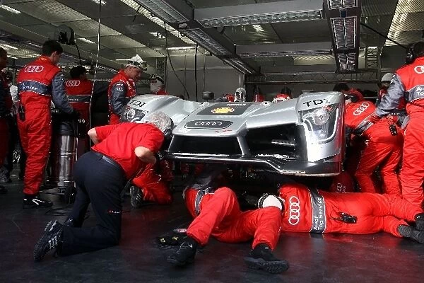 Le Mans 24 Hours: Audi mechanics work on the underneath of the R15