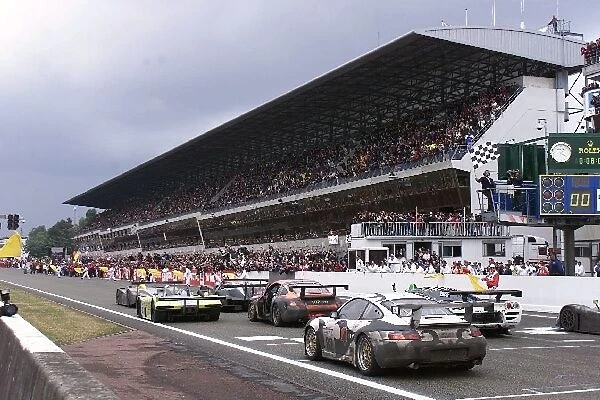 Le Mans 24 Hours: Jacky Ickx shows the chequered flag to the winners