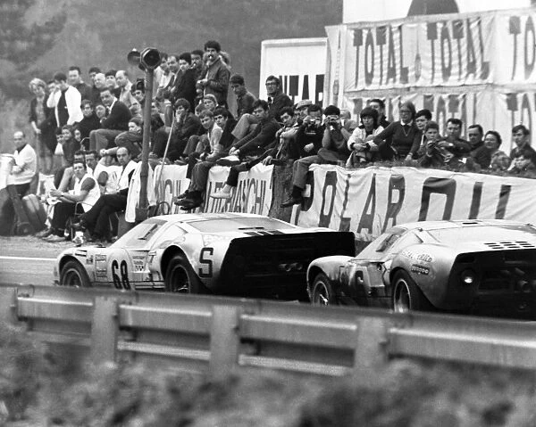 Le Mans, France. 14-15 June 1969: Helmut Kelleners  /  Reinhold Joest, Ford GT40, 6th position, leads Jacky Ickx  /  Jackie Oliver, Ford GT40, 1st position