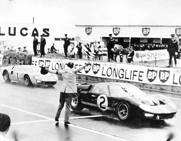 Le Mans, France. 22nd June 1966: Moment of victory for Fords, the 7 litre Ford GT40 of Bruce McLaren and Chris Amon, crosses the finish line