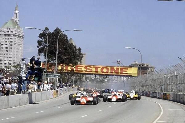 Long Beach, California, USA. 2-4 April 1982: Andrea de Cesaris leads Niki Lauda, Rene Arnoux, Alain Prost and Bruno Giacomelli at the start