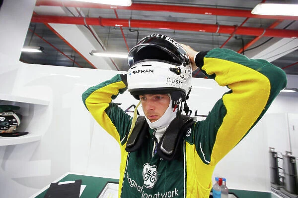 Marina Bay Circuit, Singapore. Friday 20th September 2013. Giedo van der Garde, Caterham F1 puts on his helmet in the garage. World Copyright: Charles Coates / LAT Photographic. ref: Digital Image _N7T9936