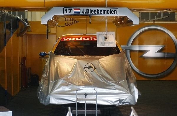 The mechanics of the OPC EuroTeam are still working on the car of Jeroen Bleekemolen