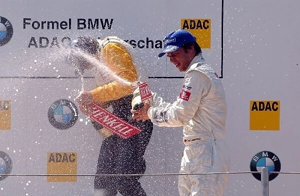 Michael Devaney (IRE), Team Rosberg, left, gets a champaign shower from Timo Lienemann