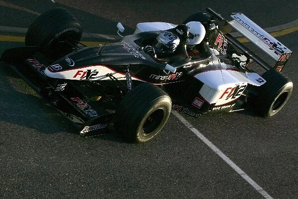 Minardi F1X2: Patrick Friesacher enters the pit lane with a passenger