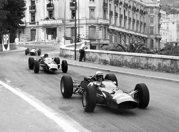Monte Carlo, Monaco. 28-30 May 1965: Lorenzo Bandini, Ferrari 1512, 2nd position, leads Graham Hill, BRM P261, 1st position, action