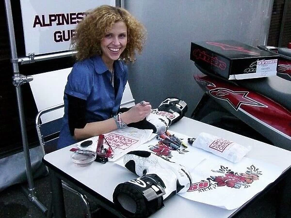 MotoGP. Jill Bradley (GBR) paints the Alpinestars boots of Nicky Hayden (USA)