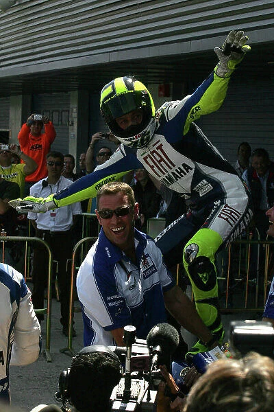 MotoGP. Valentino Rossi (ITA) Fiat Yamaha Team surfs on his bike in celebration.