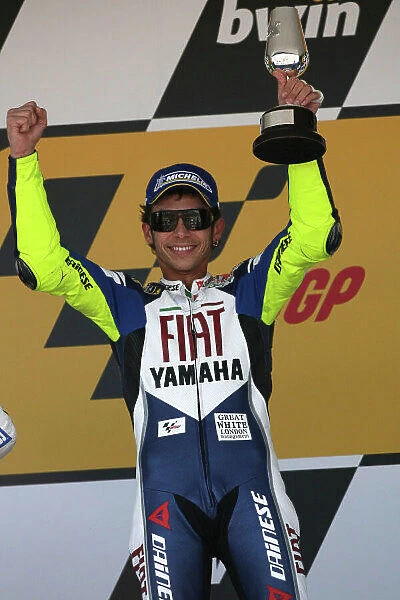 MotoGP. Valentino Rossi (ITA) Fiat Yamaha Team celebrates his win on the podium.