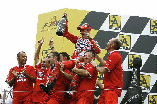 MotoGP. Casey Stoner (AUS) and his Marlboro Ducati team celebrate winning