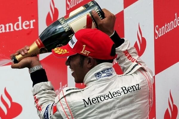 n  /  a: Lewis Hamilton McLaren celebrates on the podium with Norbert Haug Mercedes Sporting Director