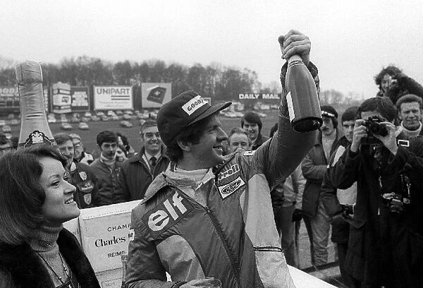 Non Championship Formula One: Jody Scheckter Tyrrell, celebrates with the traditional 100 bottles of champagne after taking pole position