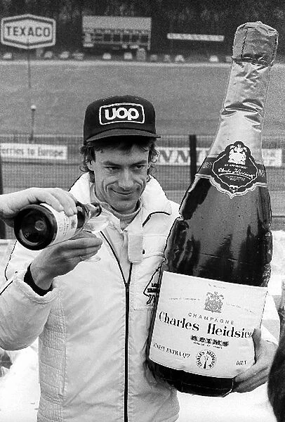 Non-Championship Formula One: Pole sitter Tom Pryce Shadow, receives his traditional champagne after claiming pole position. He went on to take his first