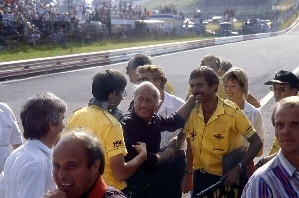 Osterreichring, Austria. 15 August 1982: Colin Chapman and the Lotus team mechanics celebrate victory: Elio de Angelis, Lotus 91-Ford, 1st position