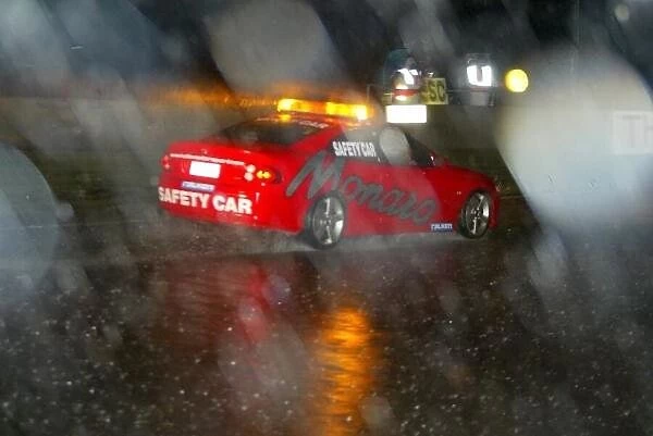f2371. The Pace Car drives through the pouring rain that stopped the racing at midnight.